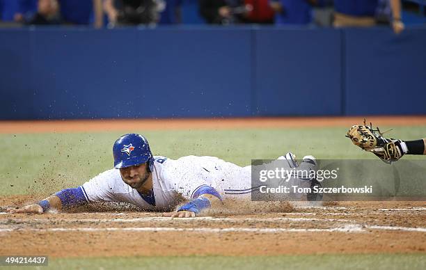 Kevin Pillar of the Toronto Blue Jays slides across home plate to score the winning run in the ninth inning during MLB game action against the Tampa...