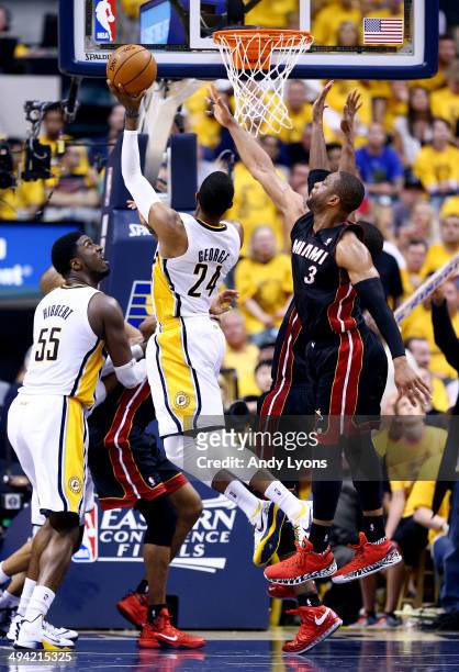 Paul George of the Indiana Pacers goes to the basket as Dwyane Wade of the Miami Heat defends during Game Five of the Eastern Conference Finals of...