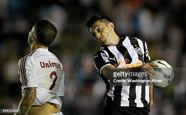 Jesus Datolo of Atletico MG struggles for the ball with Bruno of Fluminense during a match between Atletico MG and Fluminense as part of Brasileirao...
