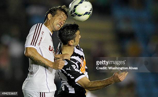 Jesus Datolo of Atletico MG struggles for the ball with Diguinho of Fluminense during a match between Atletico MG and Fluminense as part of...