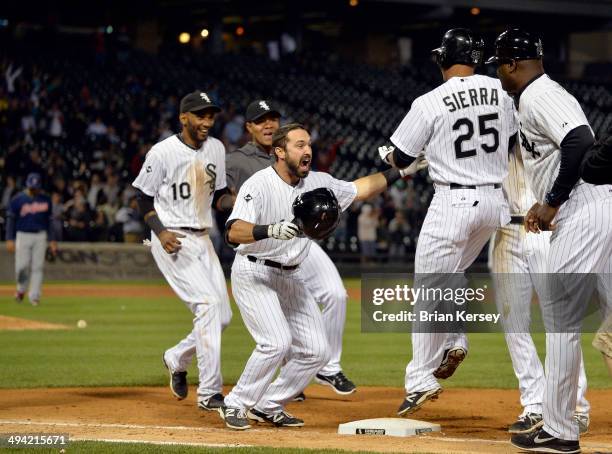 Moises Sierra of the Chicago White Sox makes sure he touched first base as he celebrates with teammates Alexei Ramirez and Adam Eaton after hitting a...