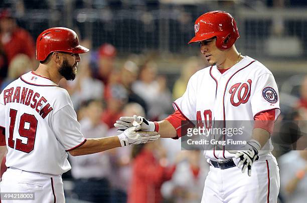 Wilson Ramos of the Washington Nationals celebrates with Kevin Frandsen after hitting a home run in the seventh inning against the Miami Marlins at...