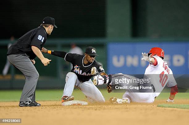 Adeiny Hechavarria of the Miami Marlins tags out Wilson Ramos of the Washington Nationals in the ninth inning at Nationals Park on May 28, 2014 in...