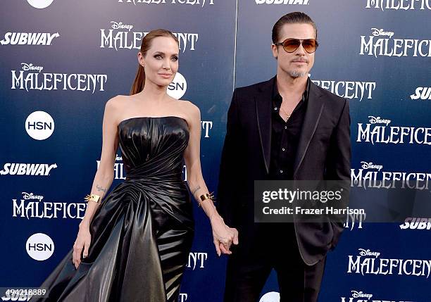 Actors Angelina Jolie and Brad Pitt attend the World Premiere of Disney's "Maleficent" at the El Capitan Theatre on May 28, 2014 in Hollywood,...