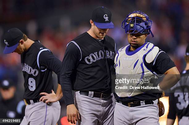 LeMahieu, Jordan Lyles and Wilin Rosario of the Colorado Rockies stand on the mound in the fifth inning against the Philadelphia Phillies at Citizens...
