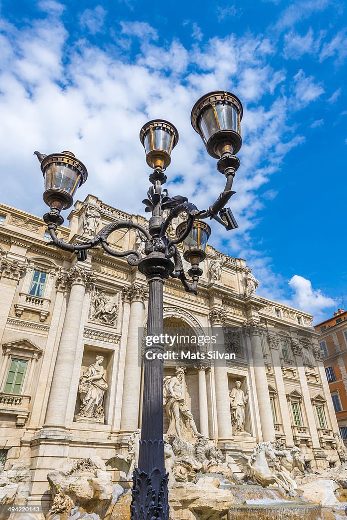 Trevi fountain and a street lamp