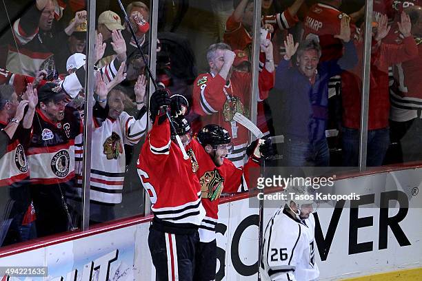 Michal Handzus of the Chicago Blackhawks celebrates with Patrick Kane after scoring a goal against Jonathan Quick of the Los Angeles Kings in double...