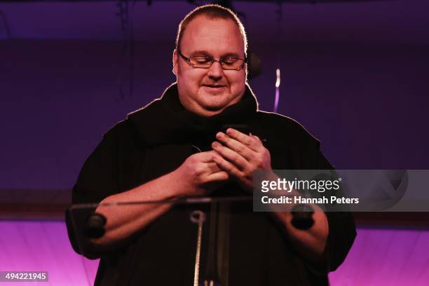 Kim Dotcom sends a tweet from his phone during a press conference announcing former leader of the Alliance Party, Laila Harre as leader of the...