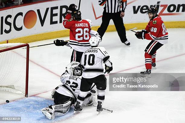 Michal Handzus of the Chicago Blackhawks scores a goal against Jonathan Quick of the Los Angeles Kings in double overtime to win Game Five of the...
