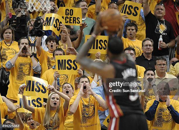 Indiana Pacers fans shout at the Miami Heat's LeBron James while he shoots free throws during the second half in Game 5 of the Eastern Conference...