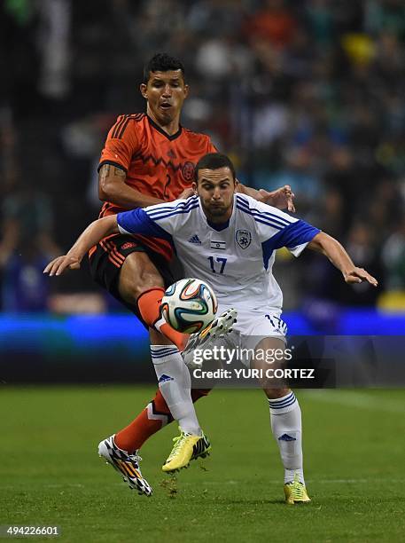 Mexico's defender Francisco Martinez battles for the ball with Israel's Ben Sahar during their friendly match at the Azteca stadium on May 28, 2014...