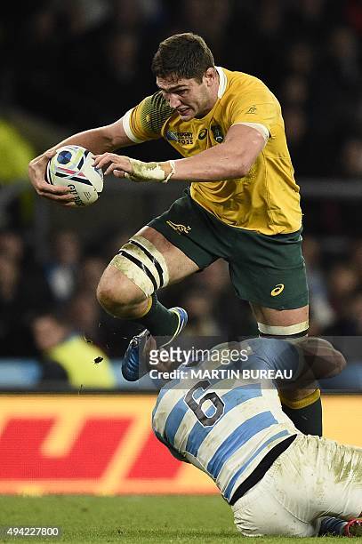 Australia's lock Rob Simmons is tackled by Argentina's flanker Pablo Matera during a semi-final match of the 2015 Rugby World Cup between Argentina...