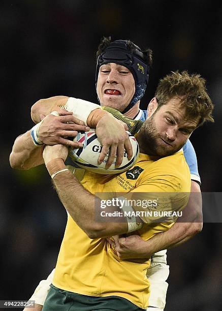 Australia's back row forward Ben McCalman is tackled during a semi-final match of the 2015 Rugby World Cup between Argentina and Australia at...