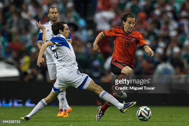 Andres Guardado of Mexico runs with the ball and evades the mark of Yossi Benayoun of Israel during a FIFA friendly match between Mexico and Israel...