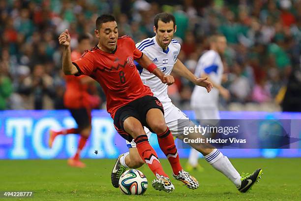 Yuval Shpungin of Israel struggles for the ball with Marco Fabian of Mexico during a FIFA friendly match between Mexico and Israel ahead the...