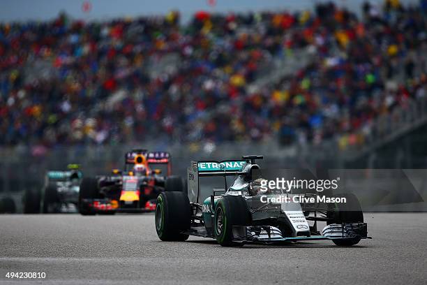 Lewis Hamilton of Great Britain and Mercedes GP leads Daniel Ricciardo of Australia and Infiniti Red Bull Racing during the United States Formula One...