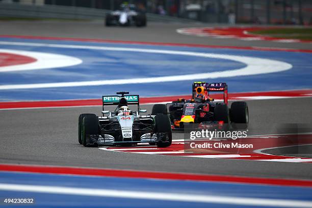 Lewis Hamilton of Great Britain and Mercedes GP leads Daniil Kvyat of Russia and Infiniti Red Bull Racing during the United States Formula One Grand...