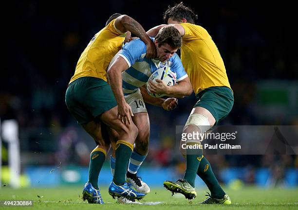 Santiago Cordero of Argentina is wrapped up by Tevita Kuridrani of Australia and Adam Ashley-Cooper of Australia during the 2015 Rugby World Cup Semi...