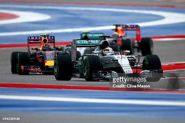 Lewis Hamilton of Great Britain and Mercedes GP leads Daniil Kvyat of Russia and Infiniti Red Bull Racing, Nico Rosberg of Germany and Mercedes GP...