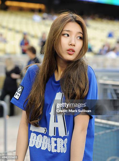 Korean singer/actress Bae Suzy, aka SUZY on the field to throw out the ceremonial first pitch before the game between the Los Angeles Dodgers and...