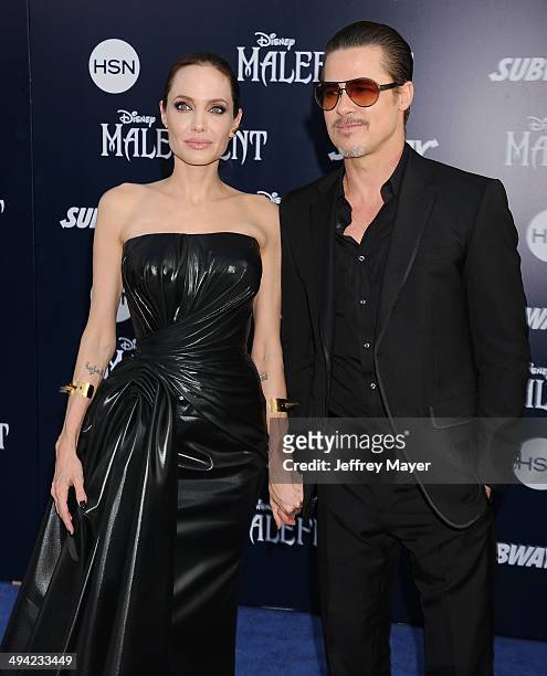 Actors Angelina Jolie and Brad Pitt arrive at the World Premiere Of Disney's 'Maleficent' at the El Capitan Theatre on May 28, 2014 in Hollywood,...