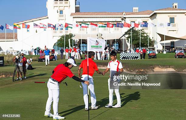 Daisuke Matsubara of Japan shakes hands with James Loew of Singapore, with Han-Ting Chiu of Chinese Taipei during the fourth round of the 27th Nomura...