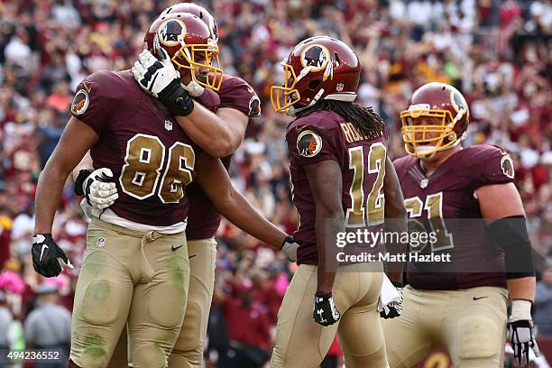 Tight end Jordan Reed of the Washington Redskins celebrates with wide receiver Andre Roberts of the Washington Redskins, guard Spencer Long of the...