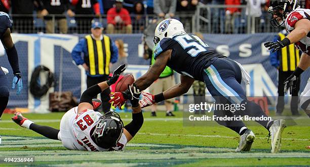 Avery Williamson of the Tennessee Titans makes an interception of a pass intended for Jacob Tamme of the Atlanta Falcons in the end zone during the...