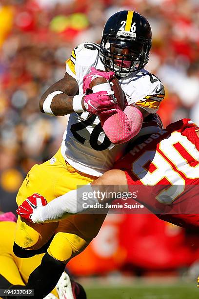 Le'Veon Bell of the Pittsburgh Steelers runs through a tackle attempt Josh Mauga of the Kansas City Chiefs at Arrowhead Stadium during the fourth...