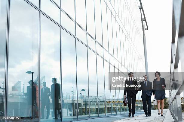 they're king players in the game of business - business man woman walking stock pictures, royalty-free photos & images