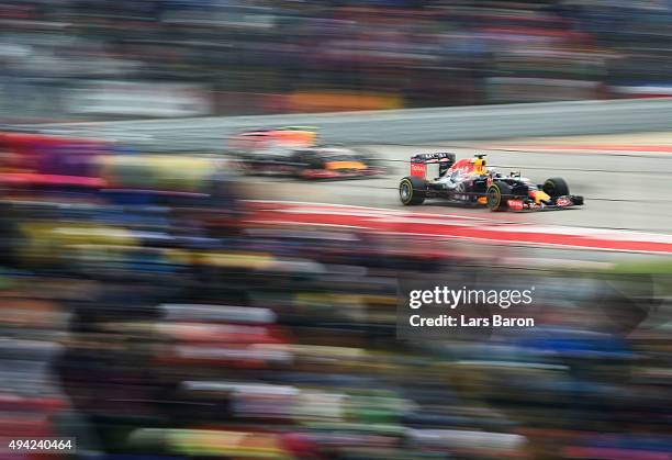 Daniel Ricciardo of Australia and Infiniti Red Bull Racing drives ahead of Daniil Kvyat of Russia and Infiniti Red Bull Racing during the United...