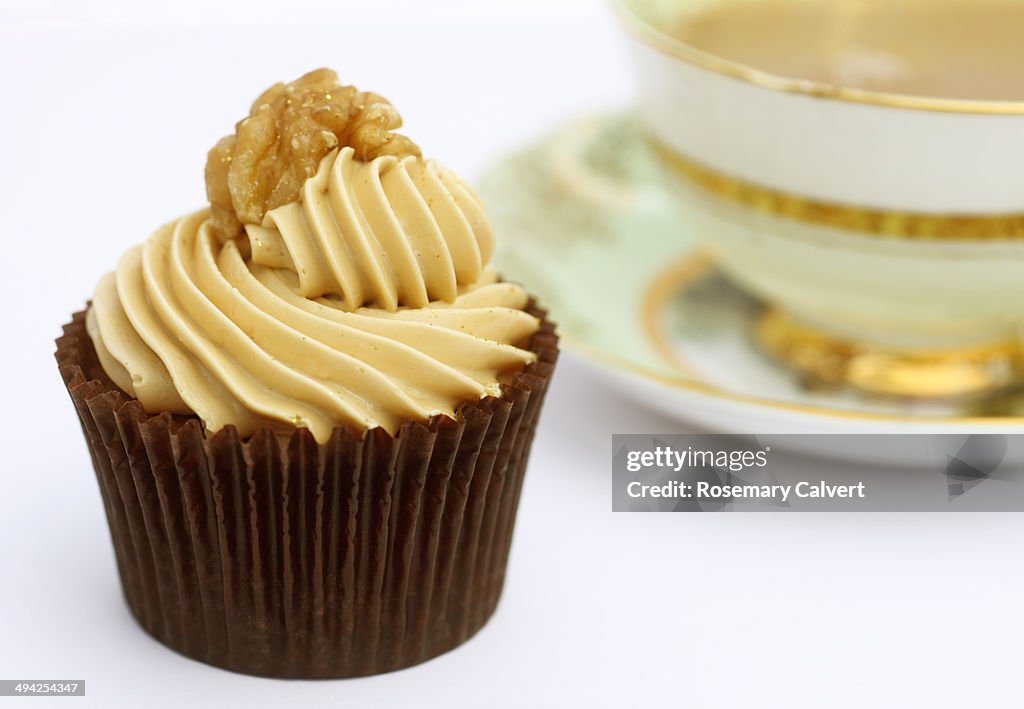 Delicious cup cake topped with coffee cream.