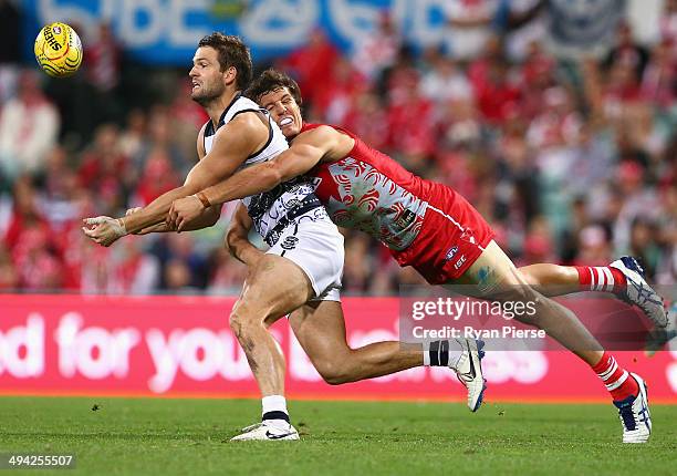 Jared Rivers of the Cats is tackled by Kurt Tippett of the Swans during the round 11 AFL match between the Sydney Swans and the Geelong Cats at the...