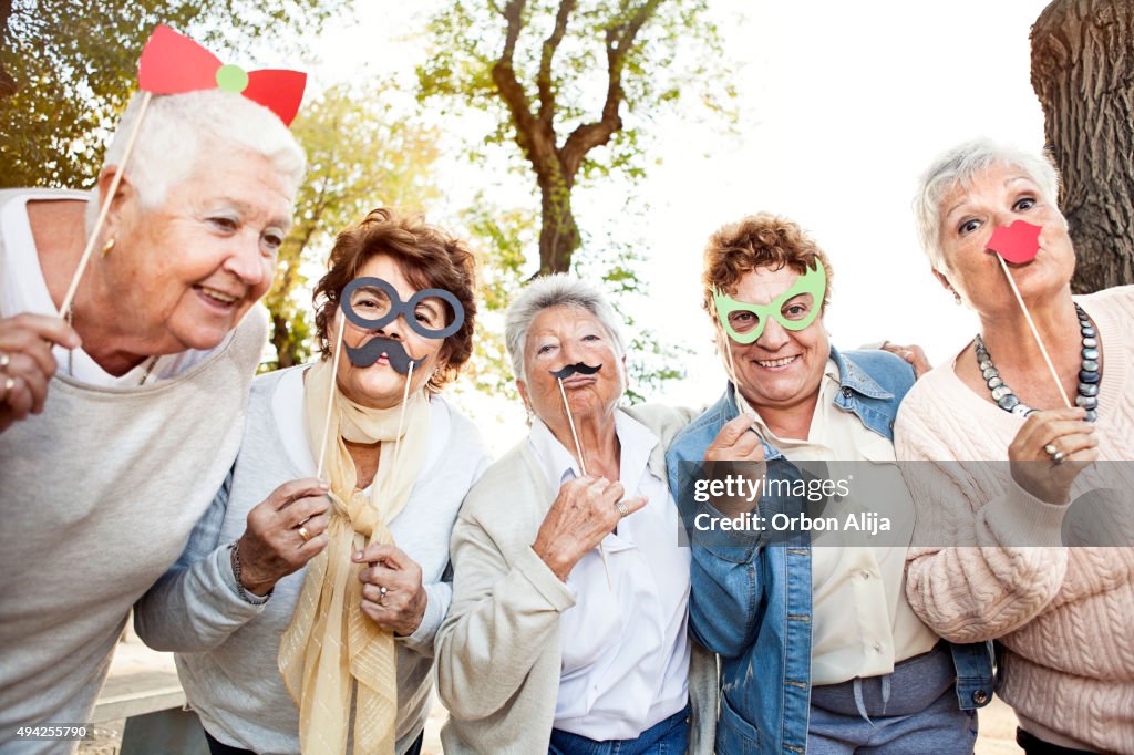 Happy senior adult women making faces