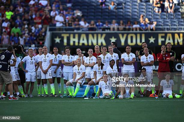 The entire United States women's team watches a dedication video on the screen for retiring players Lauren Holiday and Lori Chalupny after a women's...