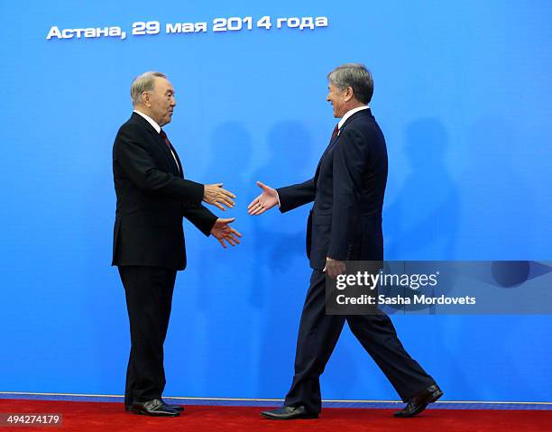 Kazakh President Nursultan Nazarbayev greets Kyrgyz President Almazbek Atambaev during the Summit of Supreme Eurasian Economic Council, on May 29,...