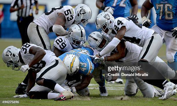 Branden Oliver $43 of the San Diego Chargers runs against the defense of the Oakland Raiders against # of during an NFL game at Qualcomm Stadium on...