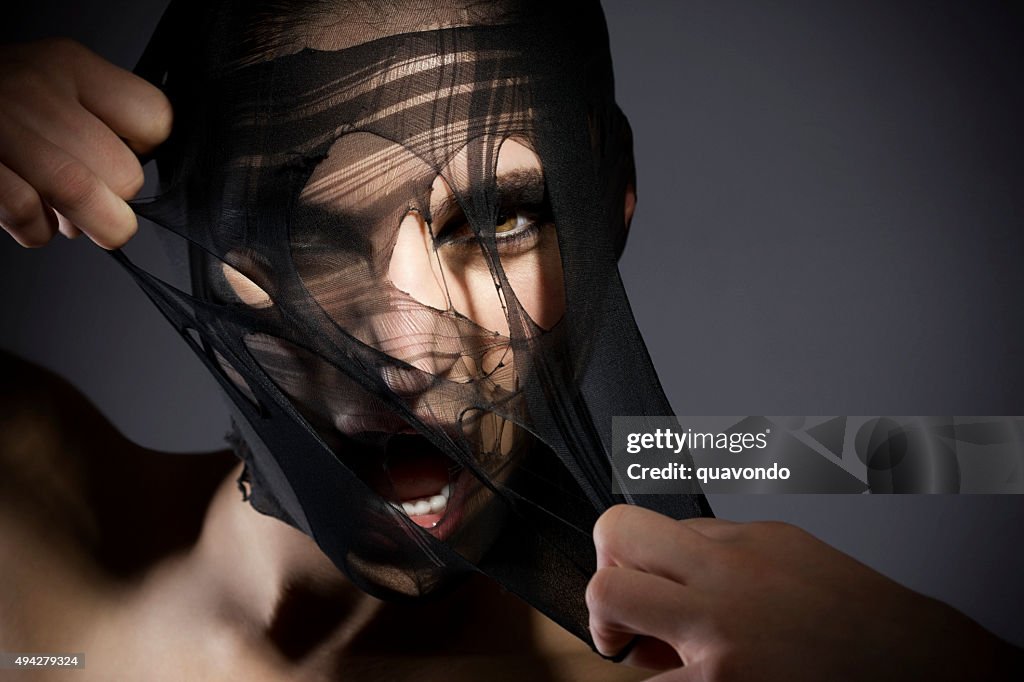 Beauty Shot of a Girl Peeling off Her Fabric Face