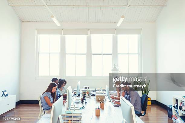 group of young business people working. - wide angle stock pictures, royalty-free photos & images