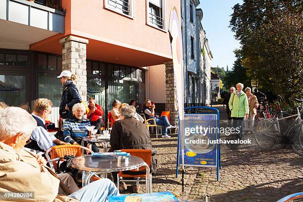 senior and adult people at ice cafe in kettwig - senior essen stock pictures, royalty-free photos & images