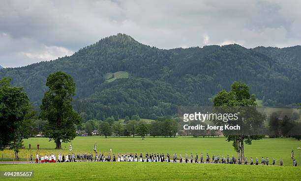 Pilgrims in traditional Bavarian folk costumes march to an outdoor mass to celebrate Ascension at the open-air altar at Birkenstein on May 29, 2014...