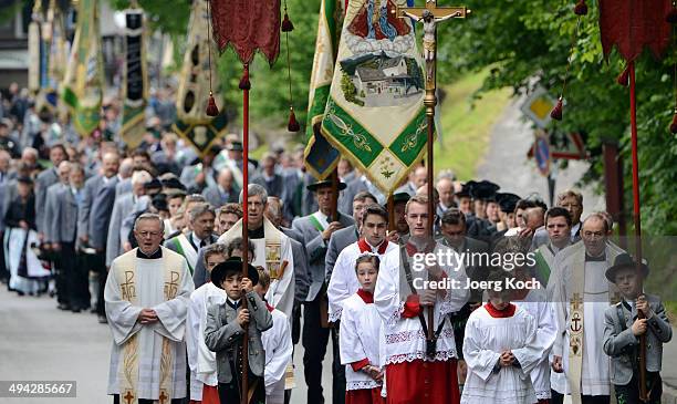 Pilgrims in traditional Bavarian folk costumes march to an outdoor mass to celebrate Ascension at the open-air altar at Birkenstein on May 29, 2014...