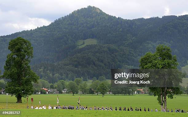 Pilgrims in traditional Bavarian folk costumes march to an outdoor mass to celebrate Ascension at the open-air altar at Birkenstein on May 29, 2014...