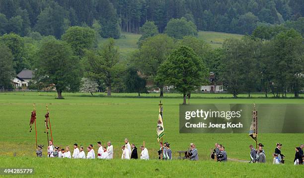 Pilgrims in traditional Bavarian folk costumes march to an outdoor mass to celebrate Ascension at the open-air altar at Birkenstein on May 29, 2014...