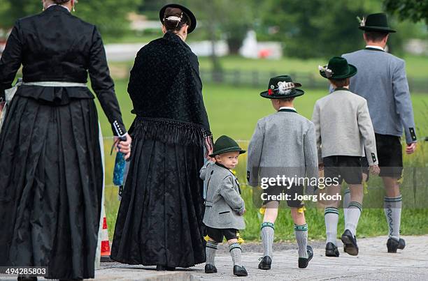 Pilgrims in traditional Bavarian folk costumes march to an outdoor mass to celebrate Ascension at the open-air altar at Birkenstein on May 29, 2014...