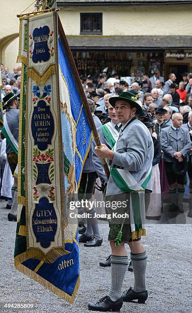 Pilgrims in traditional Bavarian folk costumes and traditional flags gather for an outdoor mass to celebrate Ascension at the open-air altar at...