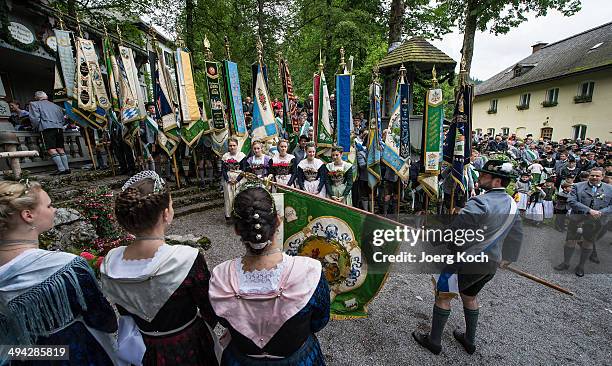 Pilgrims in traditional Bavarian folk costumes and traditional flags gather for an outdoor mass to celebrate Ascension at the open-air altar at...