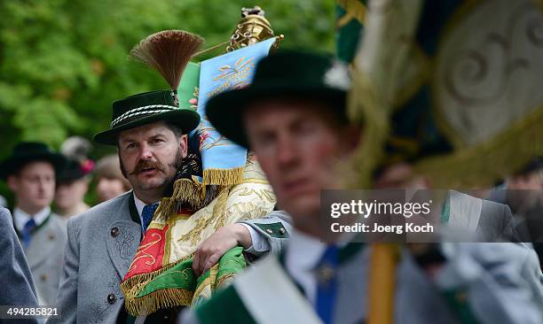 Pilgrims in traditional Bavarian folk costumes walk back to town for lunch after they have attended an outdoor mass to celebrate Ascension at the...