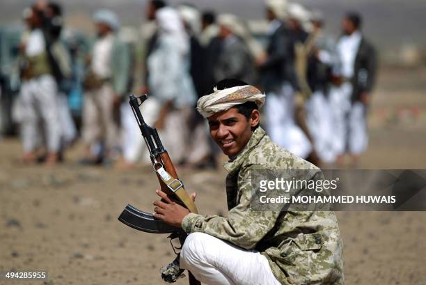An armed Yemeni tribesman attends a tribal gathering in Arhab, 20 kilometres north of Sanaa, to show support for the Yemeni army's anti-al-Qaeda...
