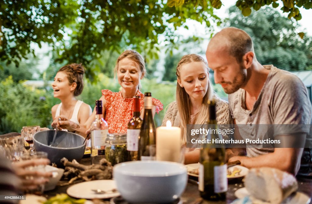 Happy Family Dinner In The Garden